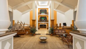 A spacious lobby with a high ceiling, a central decorative bowl, and a ship model. - Fortune Resort Benaulim Goa - Member ITC Hotels' Group (Benaulim)
