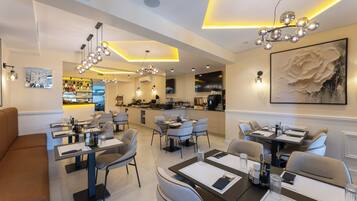 A modern dining area with tables, chairs, and a bar.