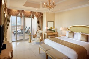 A spacious hotel room with a large bed, a desk, a chair, and a television. - Kempinski Hotel Palm Jumeirah (Dubai)