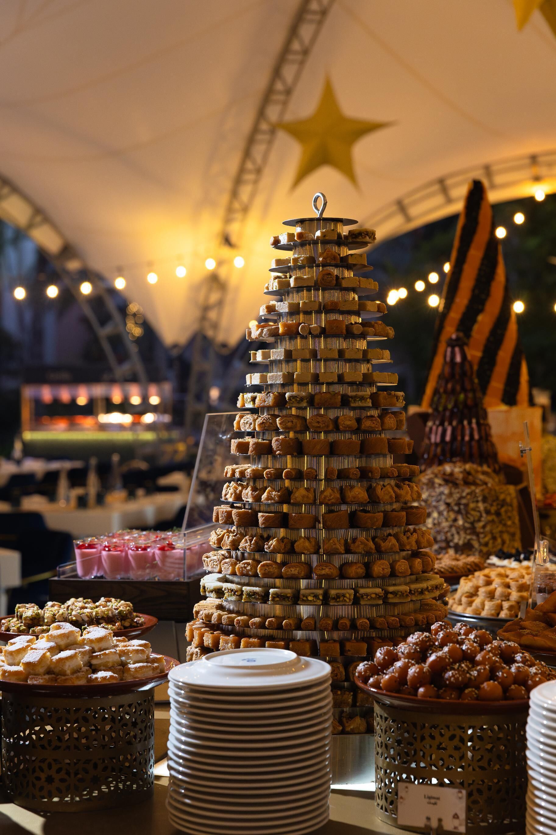 A dessert display with various pastries arranged in a pyramid shape.