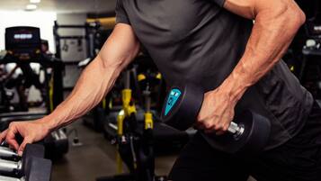 A gym with various exercise equipment, including dumbbells and weight machines.
