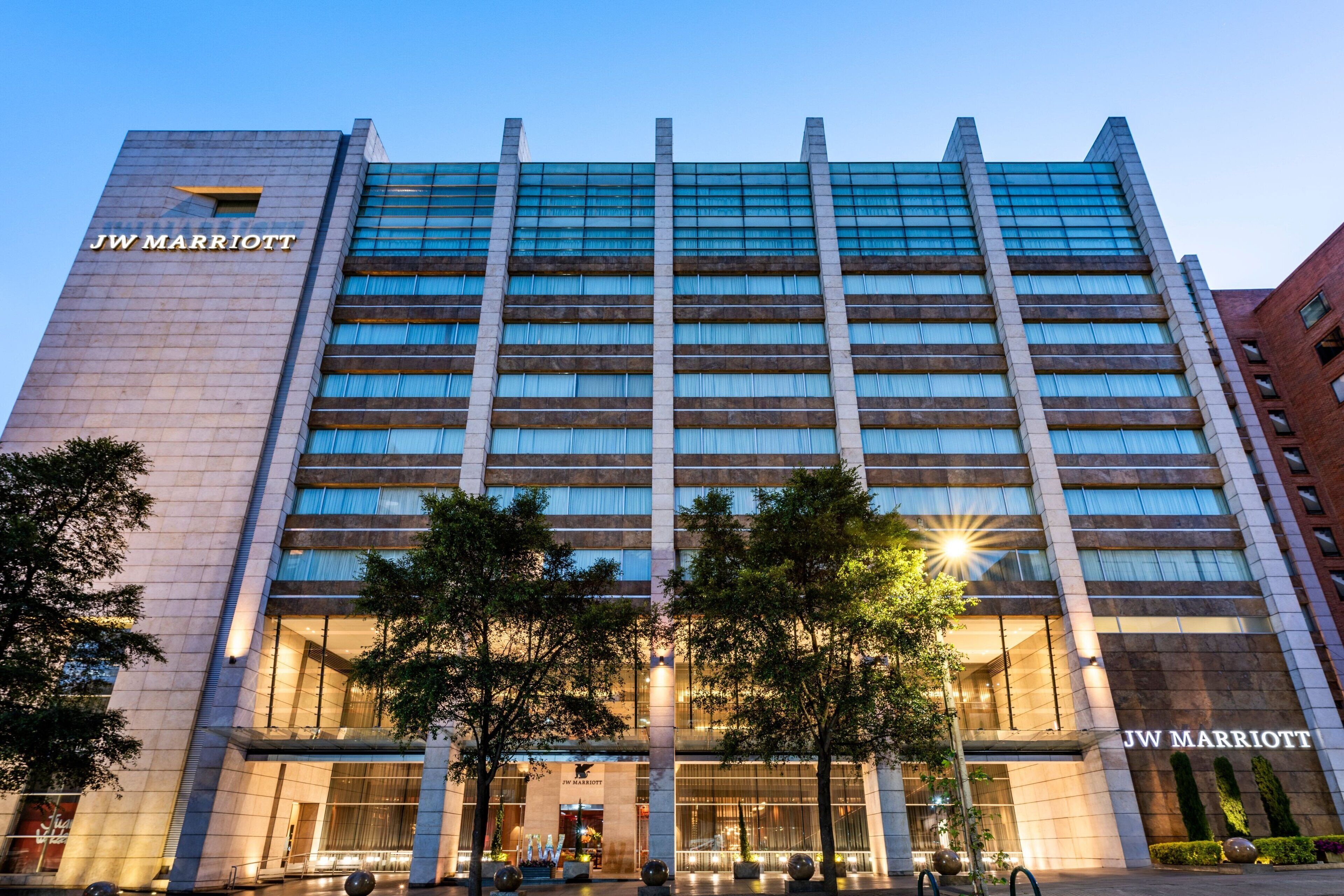 A JW Marriott hotel with a modern facade, large windows, and a prominent entrance.