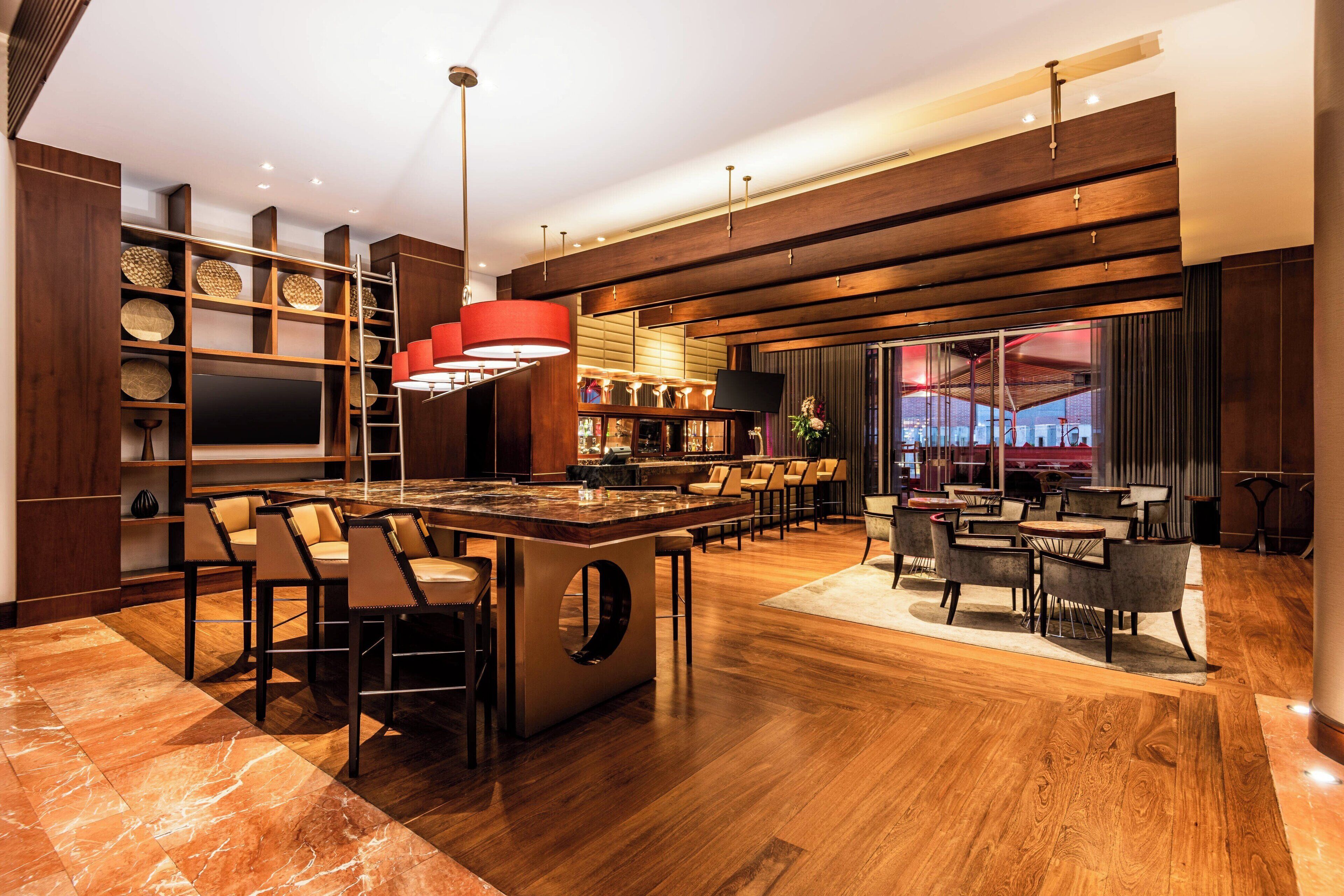 A modern kitchen with a central island, bar area, and seating.