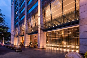 A modern building with large glass windows and a well-lit entrance area.