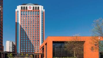 Standing tall with a striking facade, this building features a grid of windows and a flat roof.