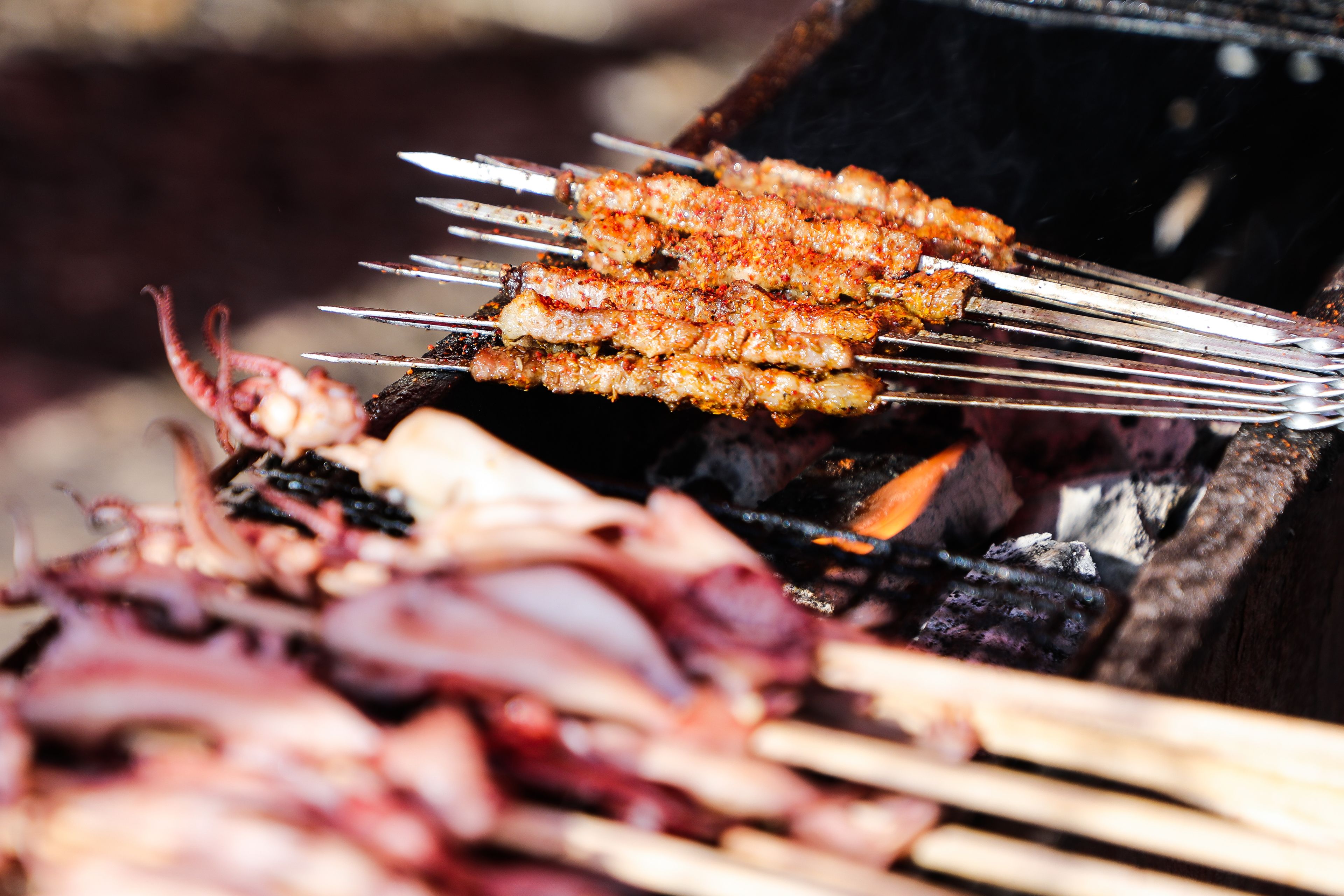 Skewers of grilled meat on a barbecue grill.