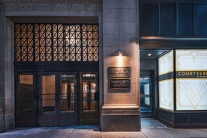 A building entrance with a metal gate, a sign for the 'Home of the Tulsa Press Club,' and a 'Courtyard by Marriott' sign. - Courtyard by Marriott Tulsa Downtown (Tulsa)