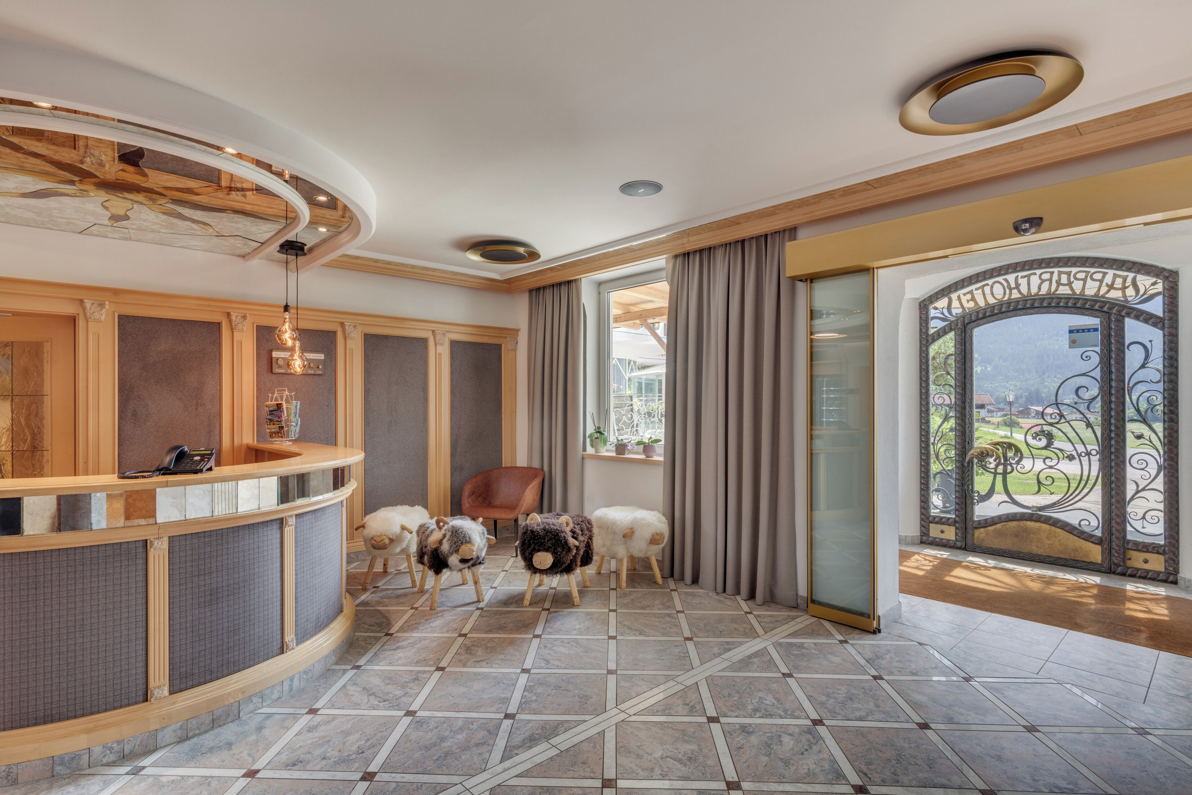 A reception area with a curved counter, a chair, and a decorative sheep sculpture.