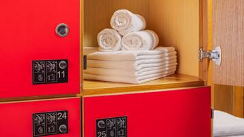 A hotel room with red storage cabinets, each marked with a number and a symbol indicating a specific function.