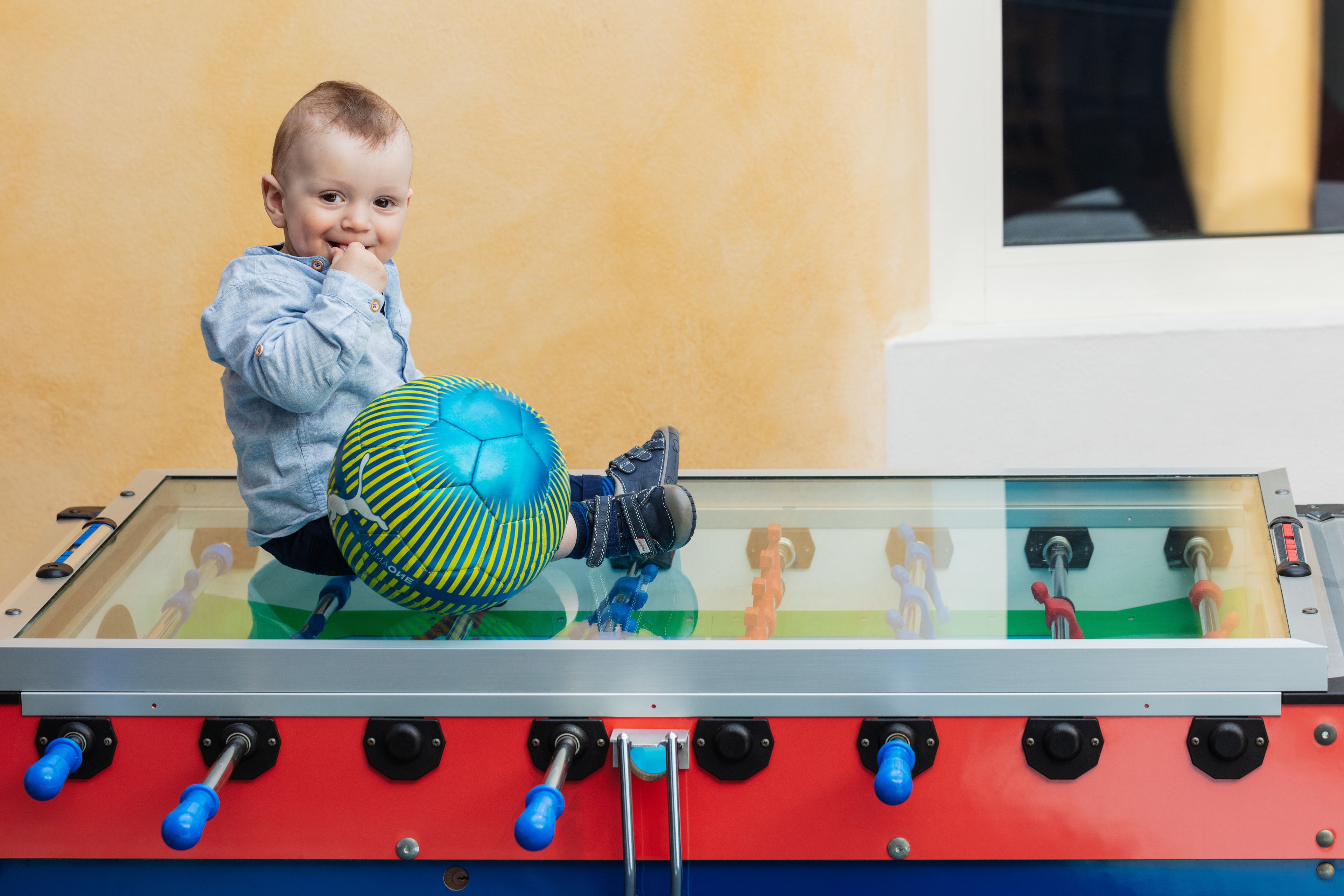 A child playing with a foosball table.