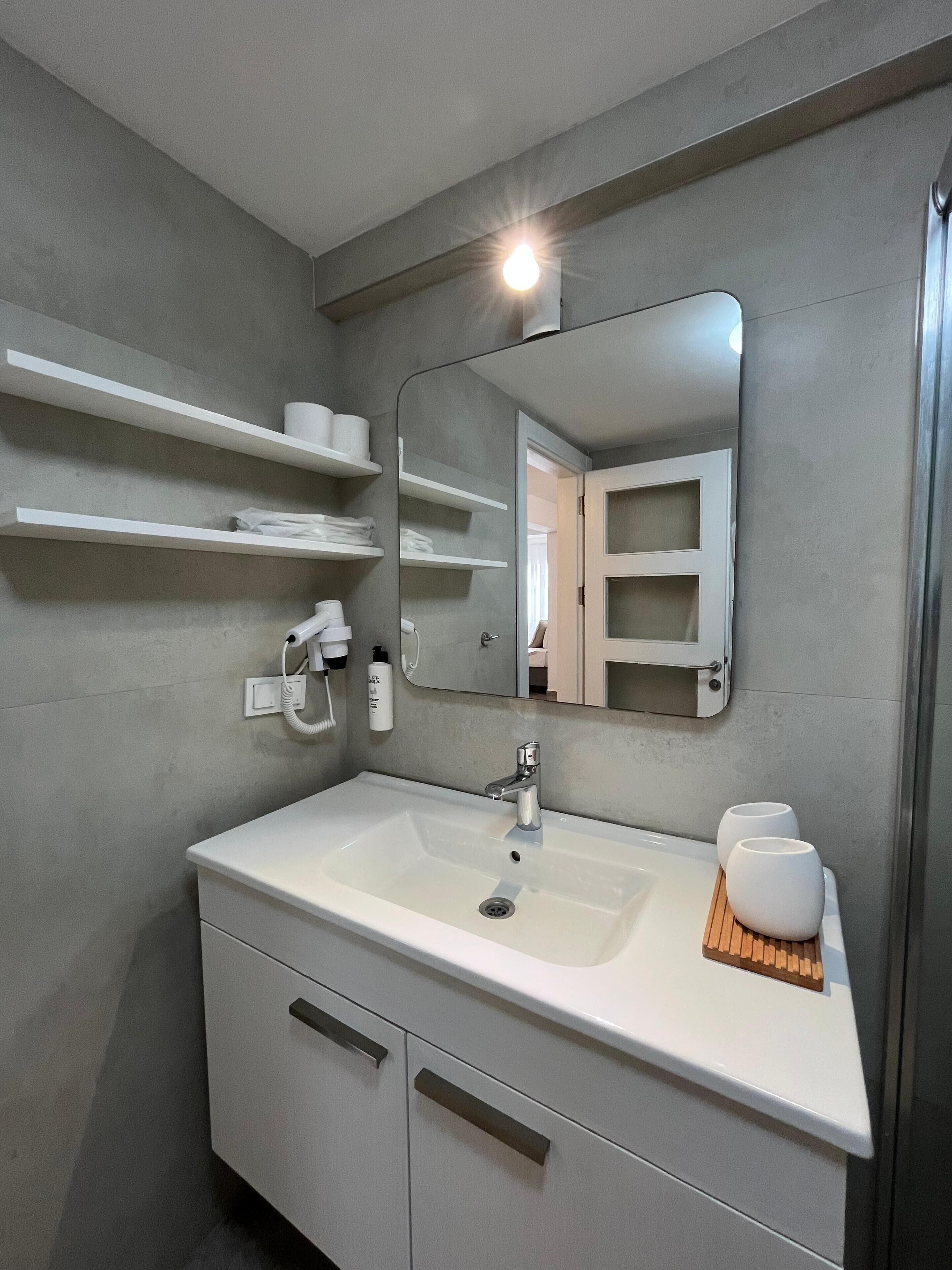 family studio suite | bathroom | shower, free toiletries, hair dryer, slippers