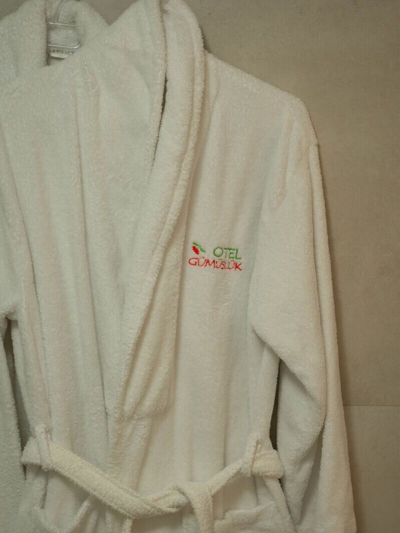 A white bathrobe with a logo on the front.