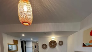 A modern hotel room with a bed, a desk, and a hanging light fixture. - Hotel Gumusluk (Bodrum)