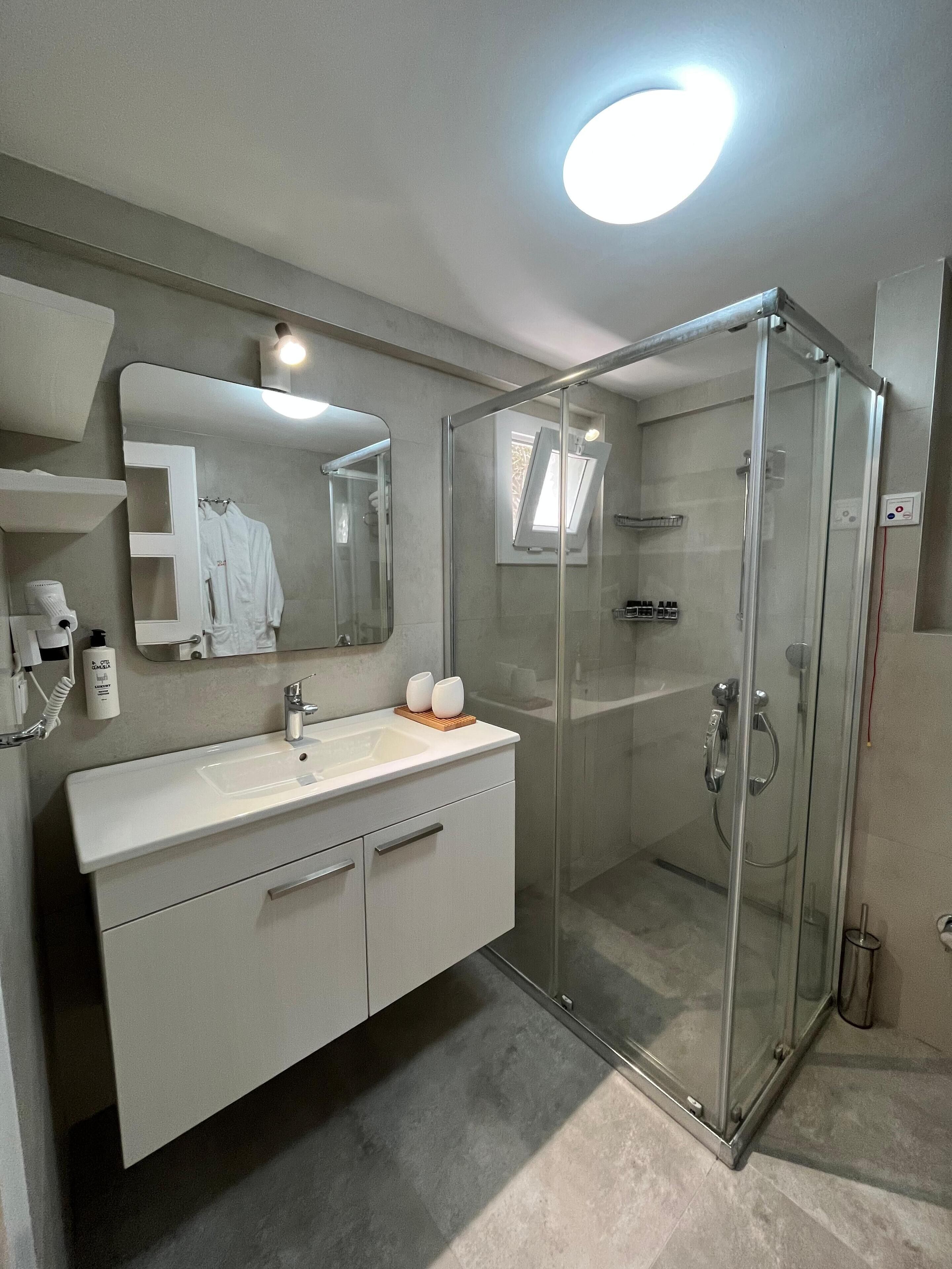 family studio suite | bathroom | shower, free toiletries, hair dryer, slippers
