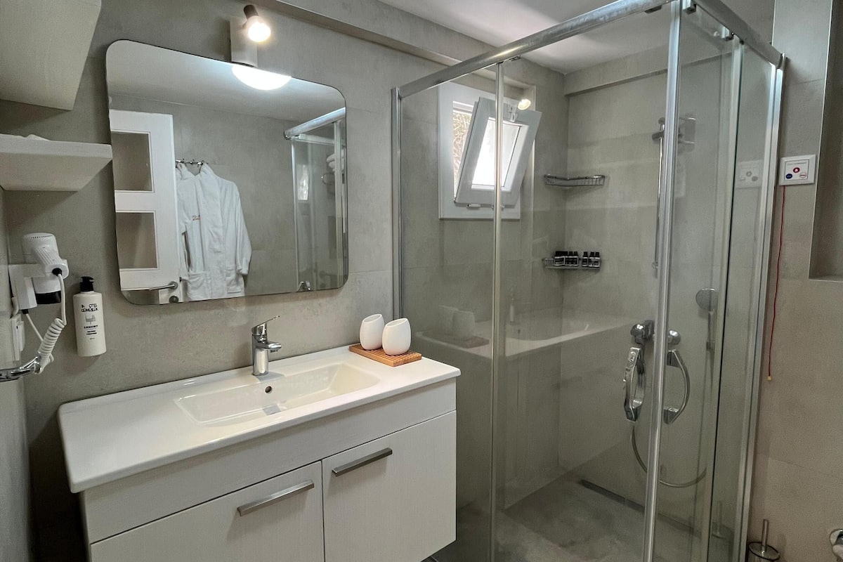 family studio suite | bathroom | shower, free toiletries, hair dryer, slippers