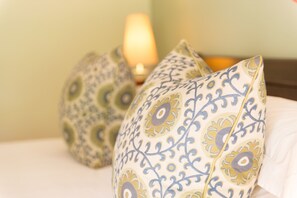 A bed with decorative pillows and a bedside lamp. - Ghost Mountain Inn (Jozini)