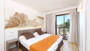 A hotel room with a bed, a nightstand, a large window, and a balcony with a table and chairs. - Apartamentos Jade - Adults Only +16 (Palma de Mallorca)