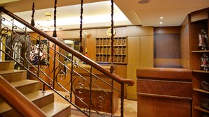 A staircase with ornate metal railings leading to a wooden landing. - Le Cedrus Hotel (Al Arz)