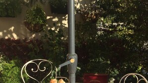 An outdoor breakfast setup with a table, chairs, and a variety of food and drink items. - Hôtel Danemark (Nice)