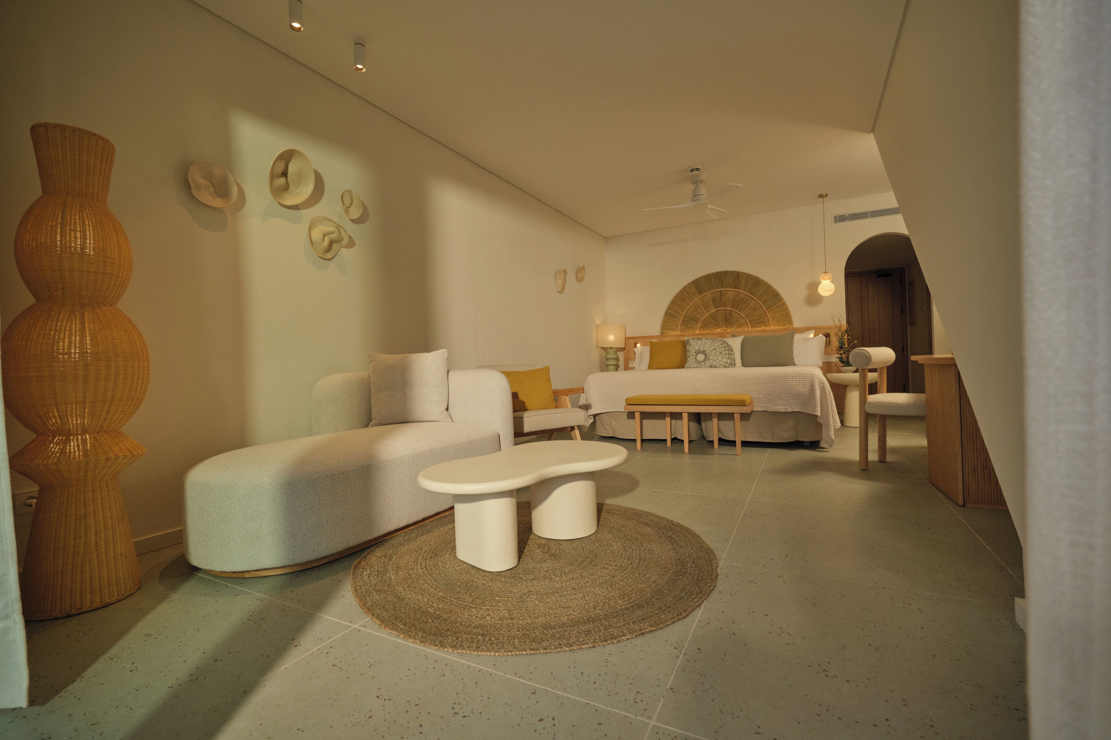 A modern living room with a sofa, a coffee table, and a large vase.