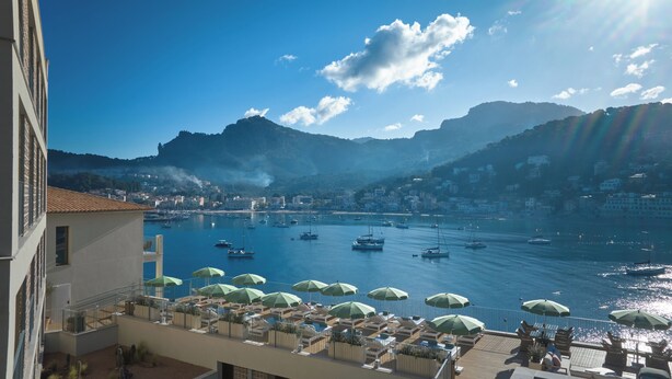 A coastal view with boats, a marina, and a mountain backdrop. - Hotel Salino Port Soller - Adults Only +16 (Sóller)