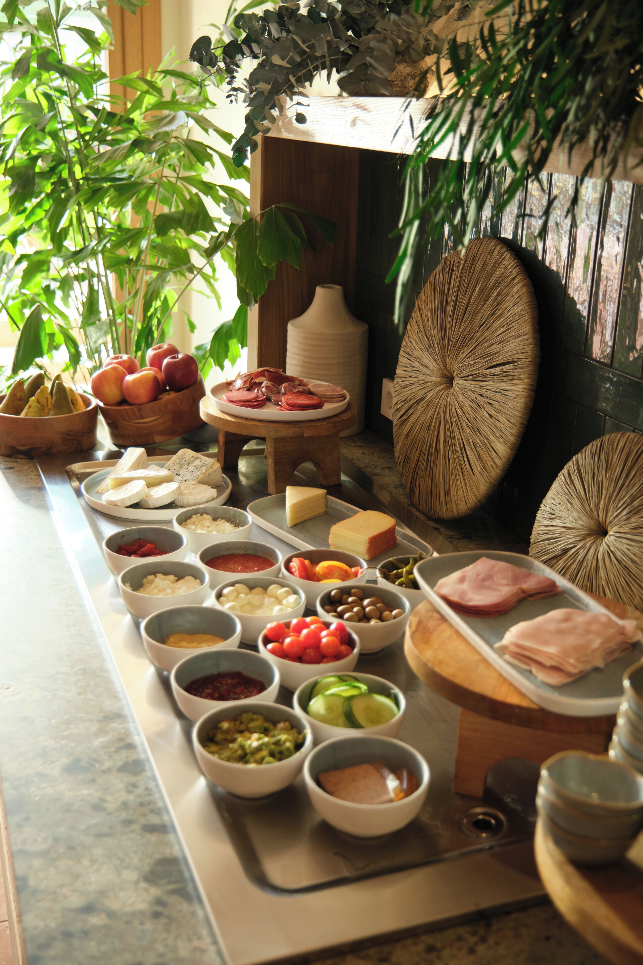 A buffet table with various food items and condiments.