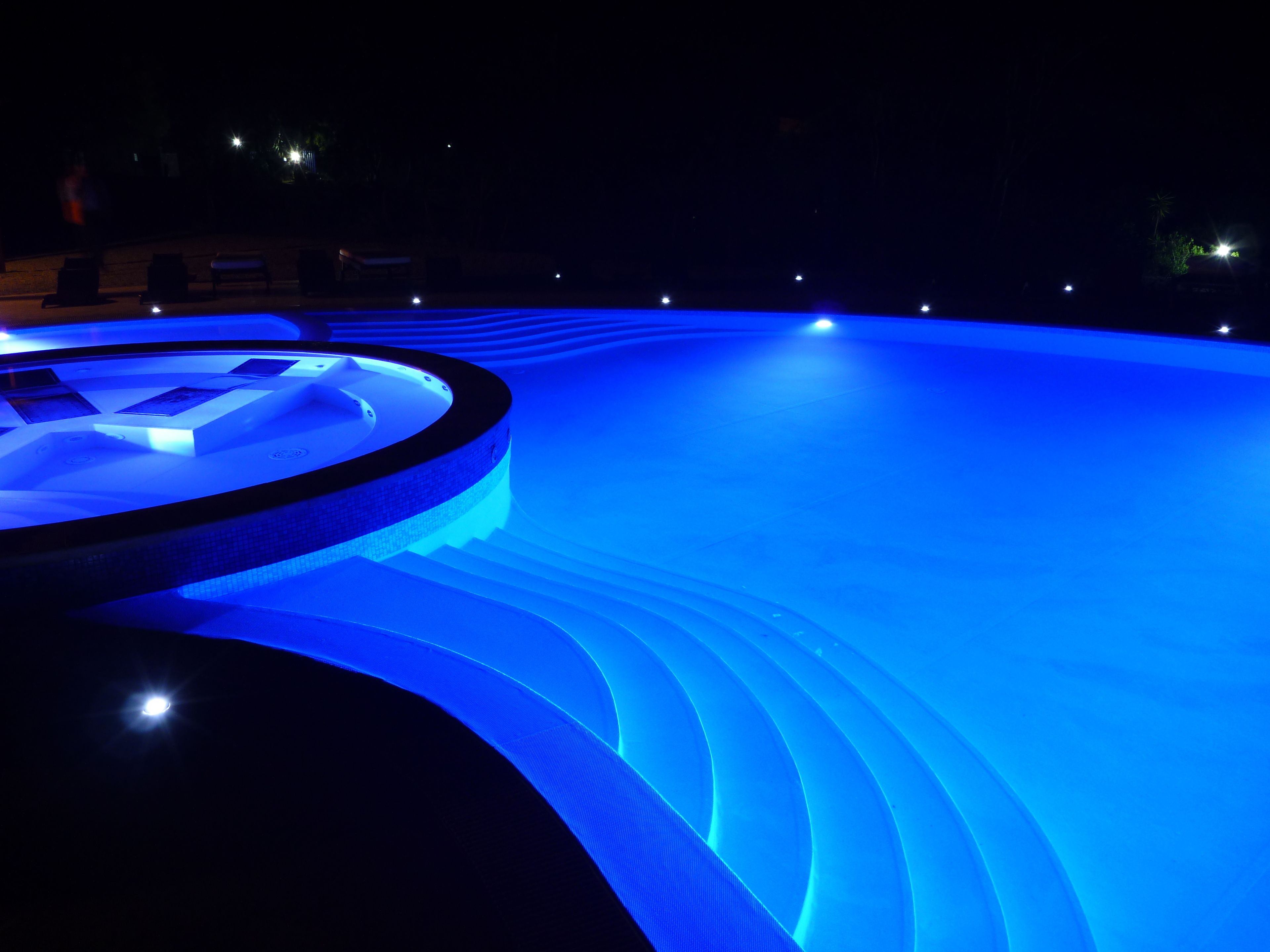 Ein Pool mit kreisförmigem Design und blauer Beleuchtung.