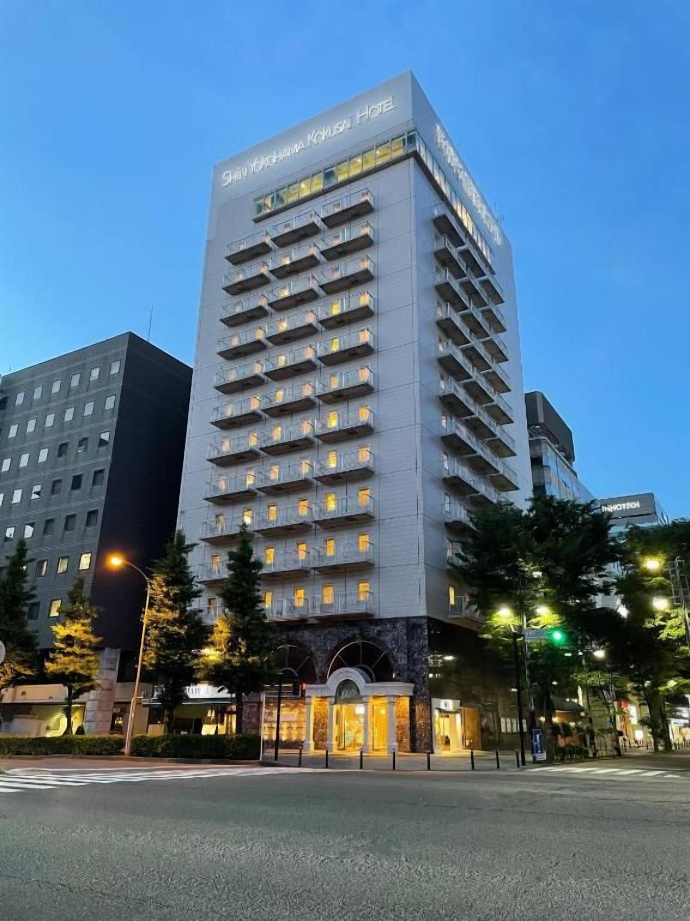 A multi-story hotel with a modern design, featuring a prominent entrance and a series of balconies.