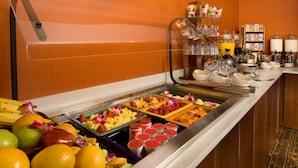 A buffet with various fruits and beverages. - DoubleTree by Hilton Sterling - Dulles Airport (Sterling)