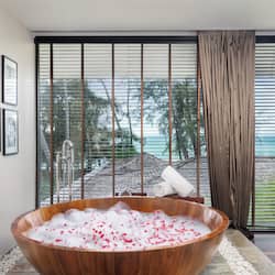 Relax in a serene space with a bathtub, outdoor area, and ocean views.