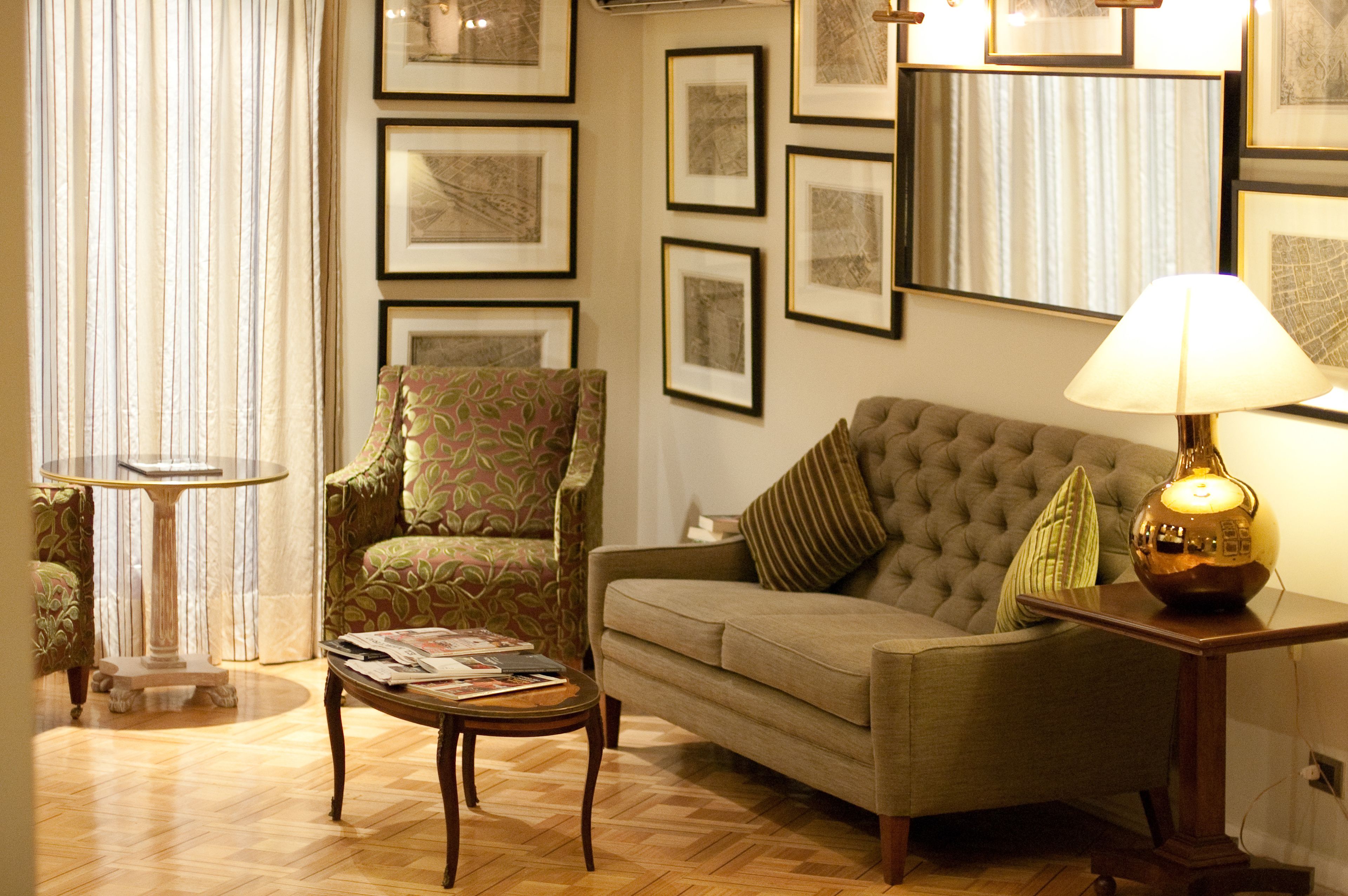 A living room with a sofa, armchair, coffee table, and lamp.
