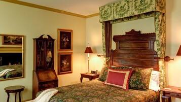 A traditional bedroom with a wooden bed, two bedside tables, and a mirror.