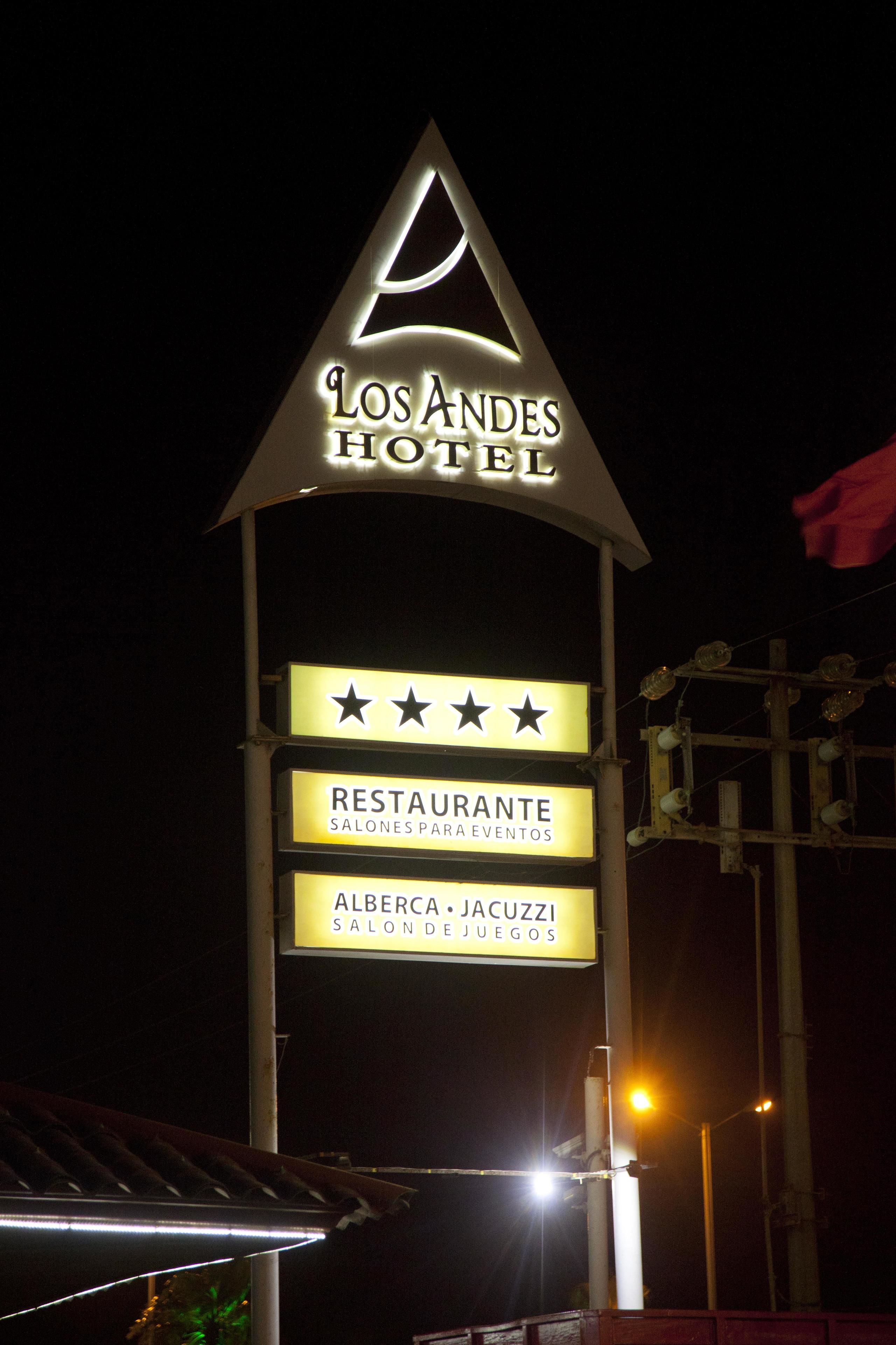 A hotel sign with a star rating and mentions a restaurant and games.