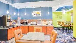 A breakfast area with a counter, seating, and a sign reading "Daybreak Breakfast".