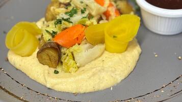 A plate of food with vegetables and a side of sauce.