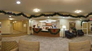 A hotel lobby with a reception desk, a waiting area with sofas, and a hallway leading to rooms. - Candlewood Suites Ft Stockton by IHG (Fort Stockton)
