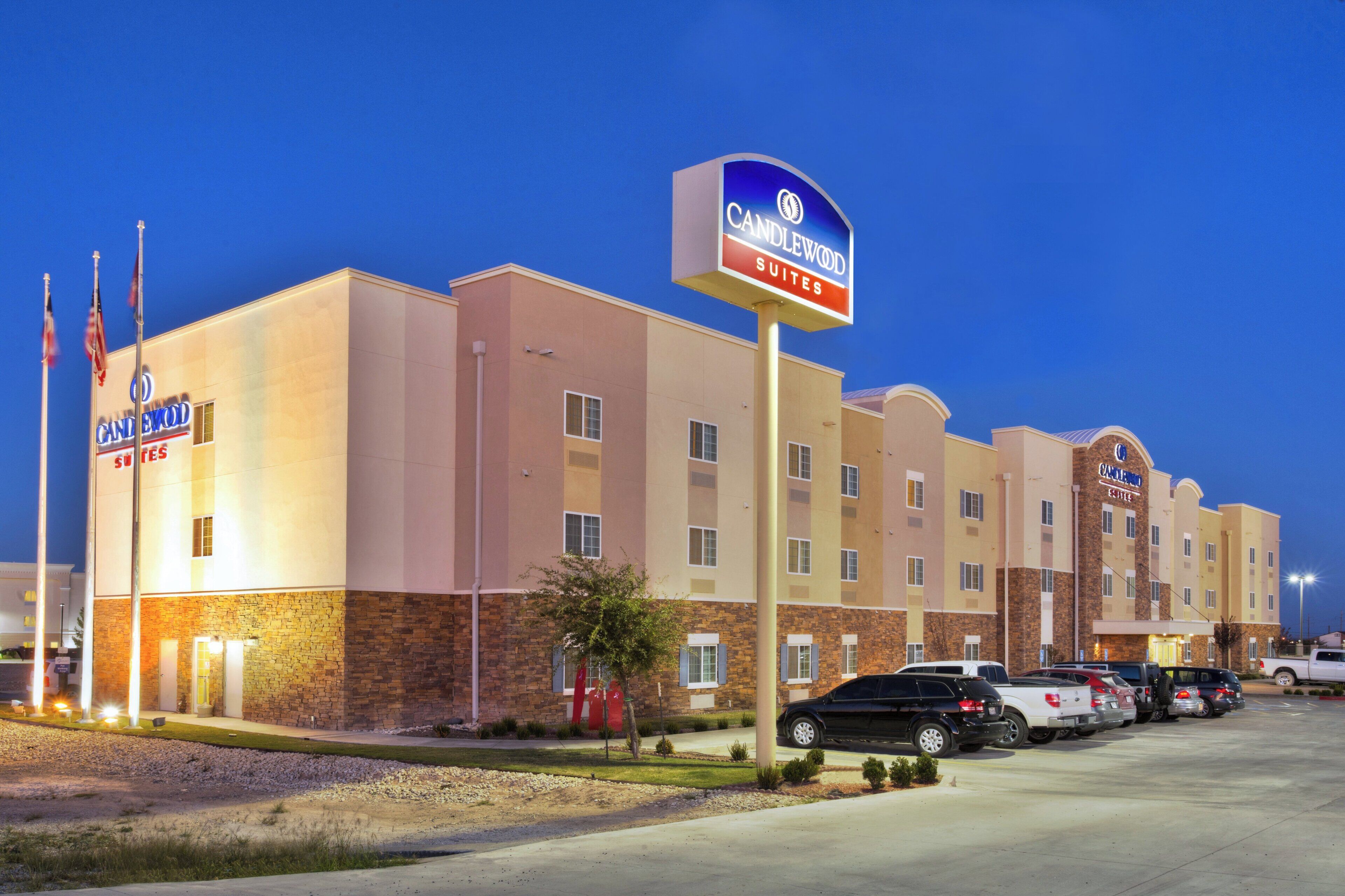 A hotel with a sign indicating 'Candlewood Suites.'
