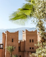 A traditional building with multiple levels and a view of distant mountains.