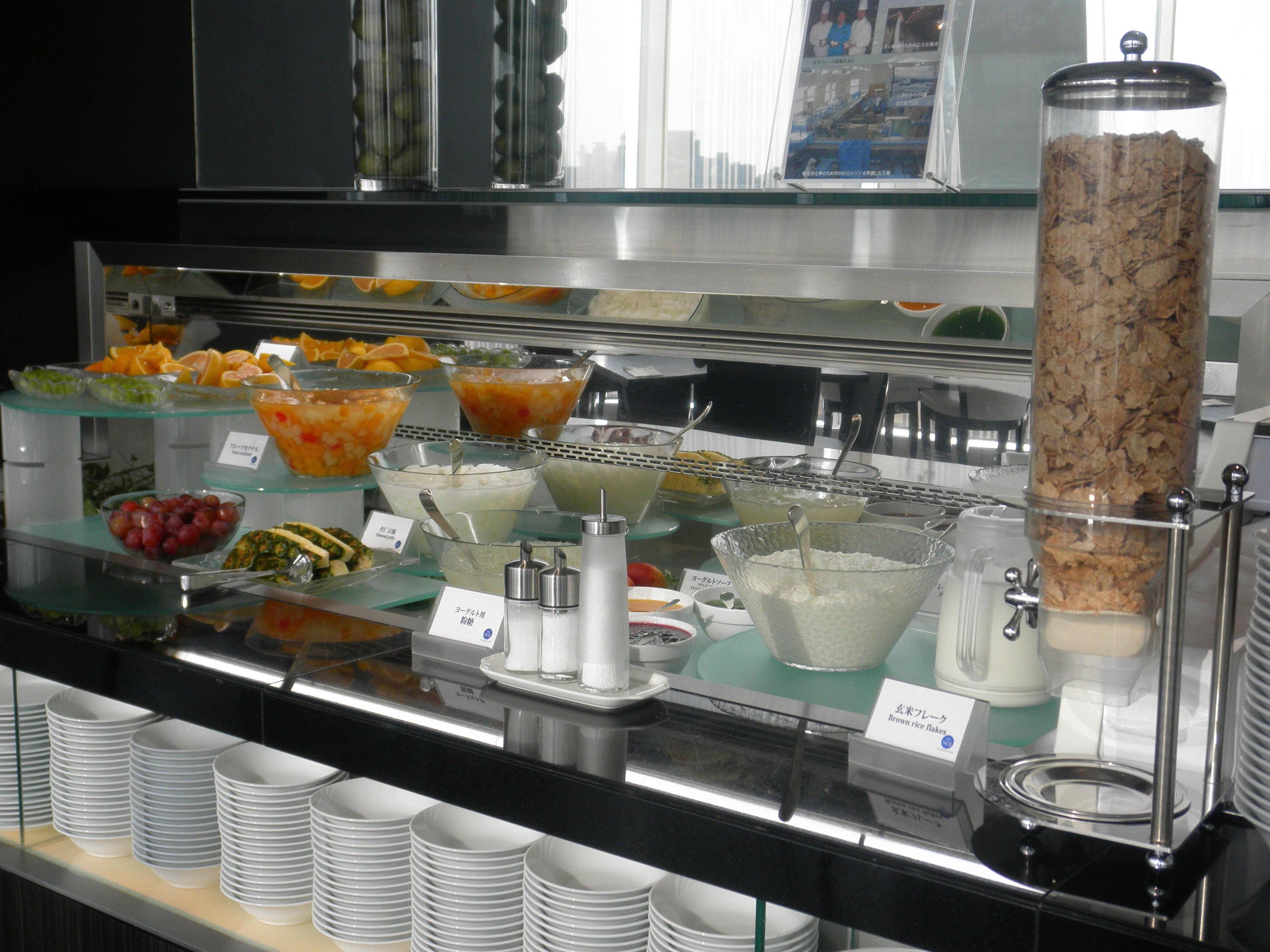 A buffet with various food items and condiments.