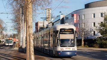 A tram with the destination 'Mevrim Grajere' on a city street.