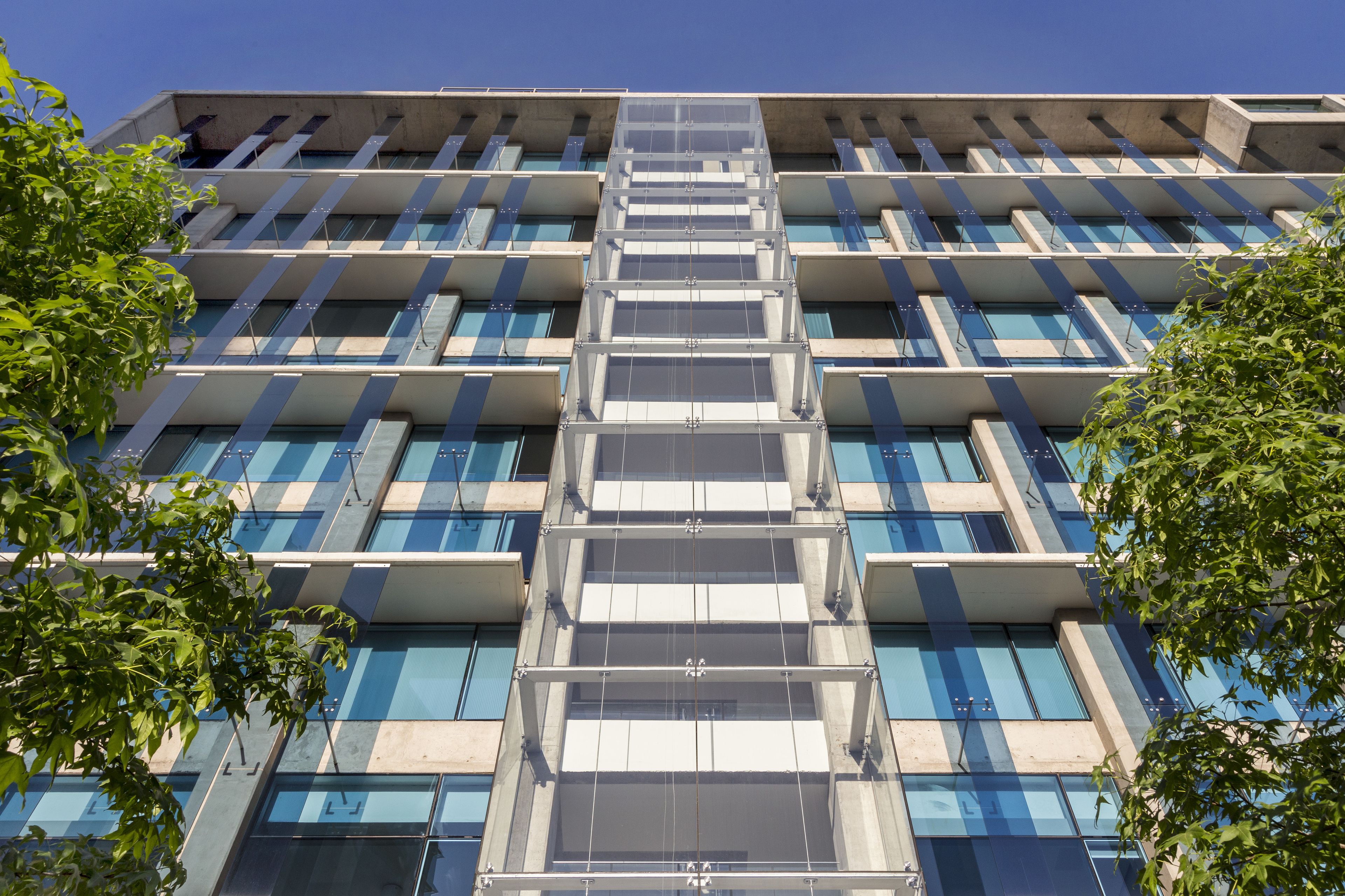 A modern building with a grid of windows and balconies.