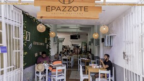 A restaurant interior with wooden signage, tables, chairs, and hanging lights. - Hotel Maya Turquesa - Playa del Carmen (Playa del Carmen)