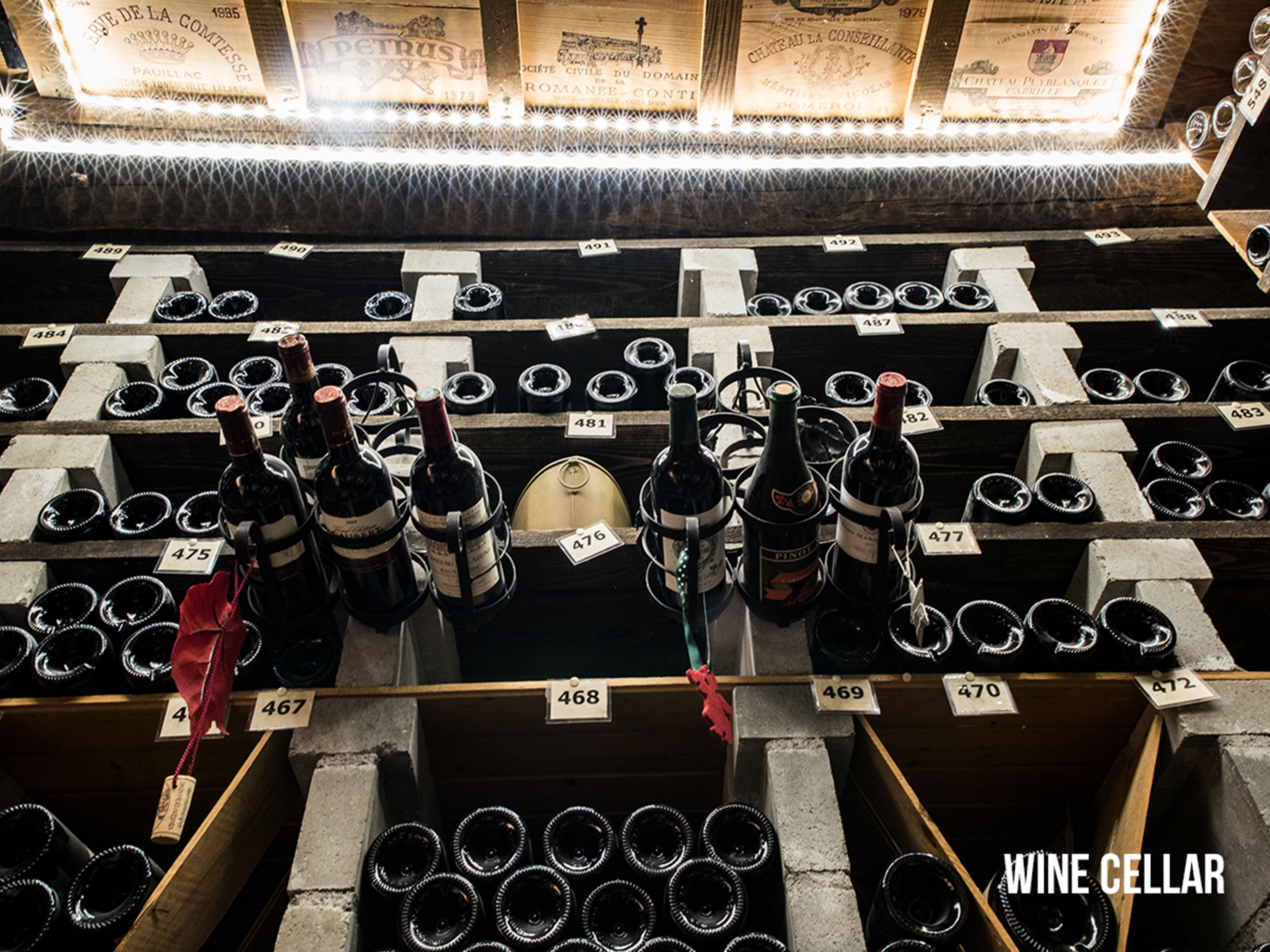 A wine cellar with rows of wine bottles and corks, each labeled with a number.
