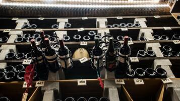 A wine cellar with rows of wine bottles and corks, each labeled with a number.
