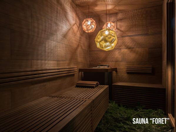 A sauna with wooden benches and hexagonal lights.