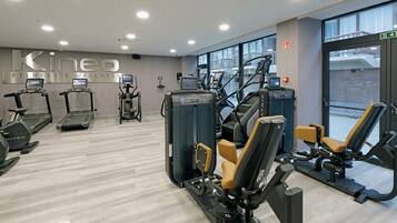 A fitness center with treadmills, elliptical machines, and weight machines.