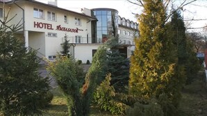 A hotel with a modern design, featuring a prominent glass facade and a sign that reads "HOTEL".
