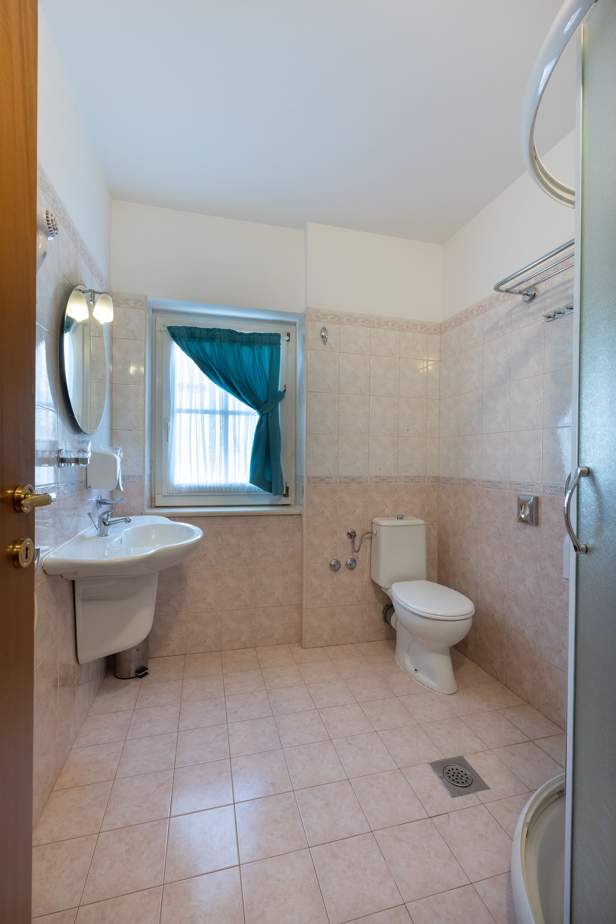 A bathroom with a sink, toilet, and shower.