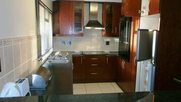 Standard Apartment, 2 Bedrooms (Self Catering & Self Servicing) | Private kitchen | Fridge, microwave, oven, stovetop
