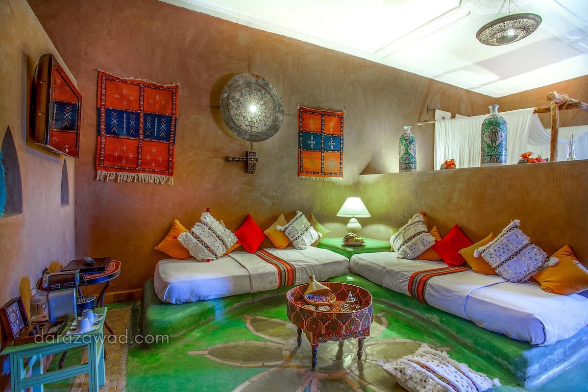 A room with two sofas, a coffee table, and a wall-mounted lamp.